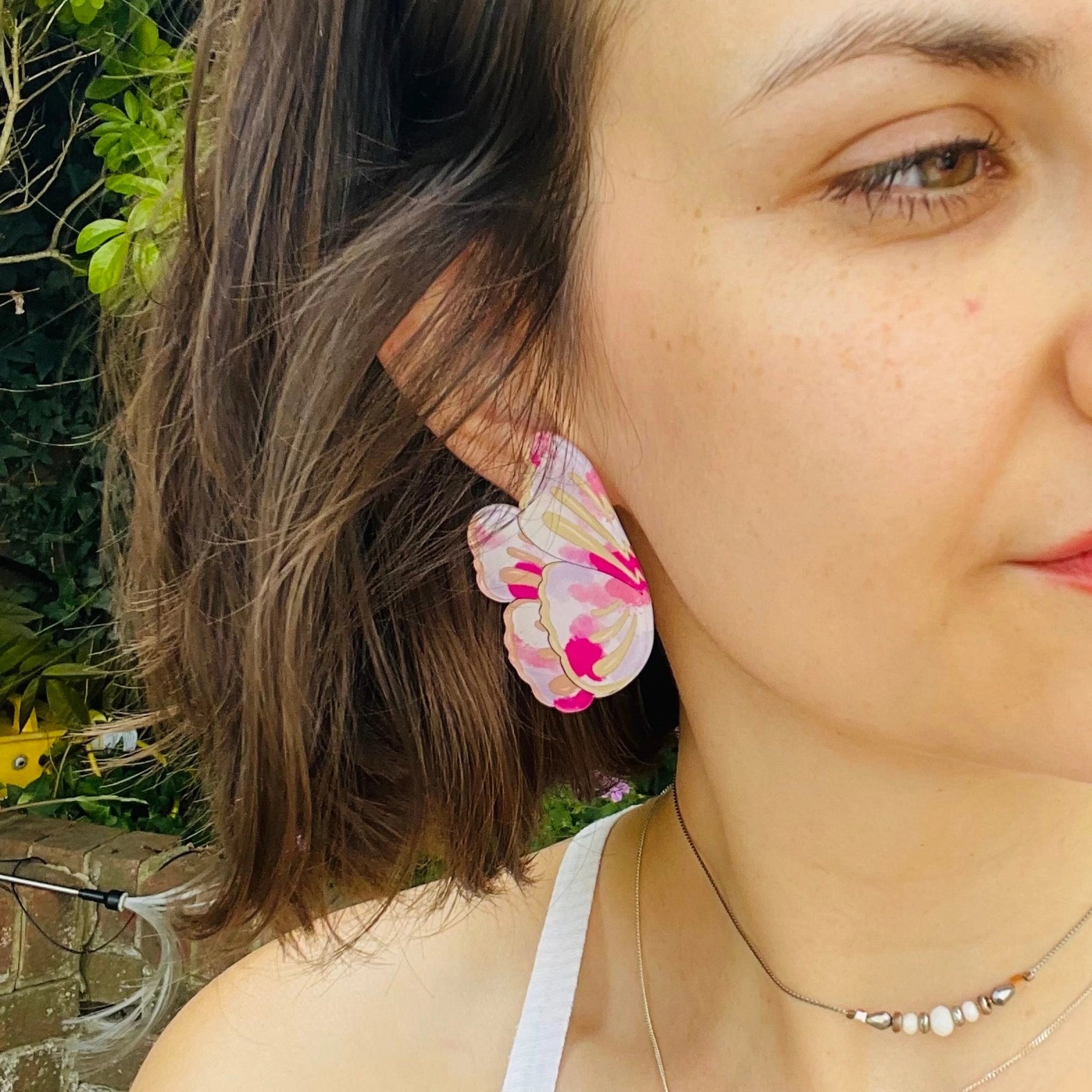 pink butterfly wing statement earrings