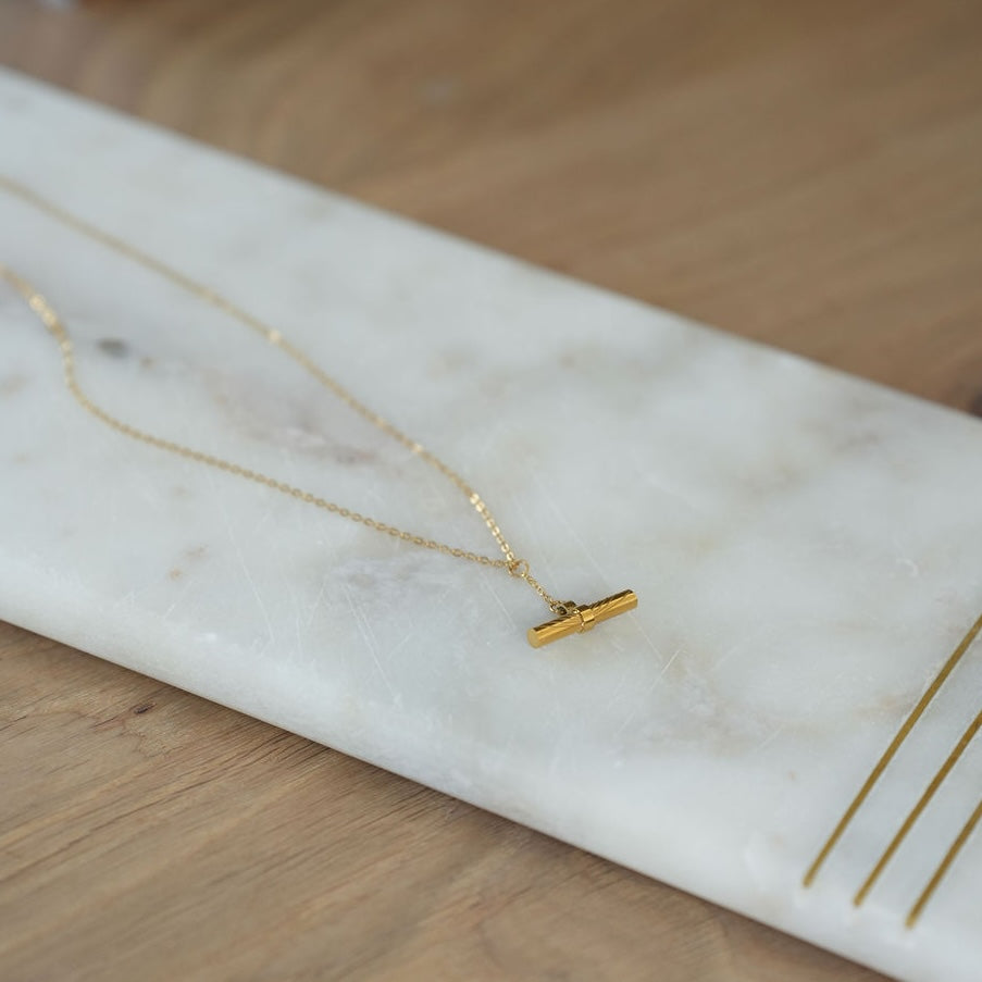 Gold necklace on a marble surface