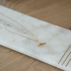 Gold necklace on a marble surface