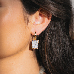 gold huggie earrings with gemstone charm 