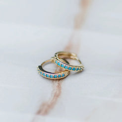 gold huggie hoops with blue cz 