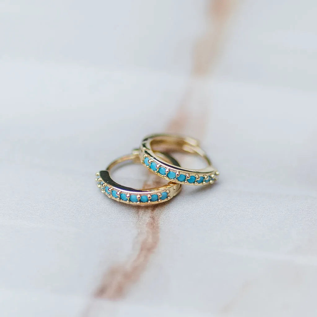 gold huggie hoops with blue cz 