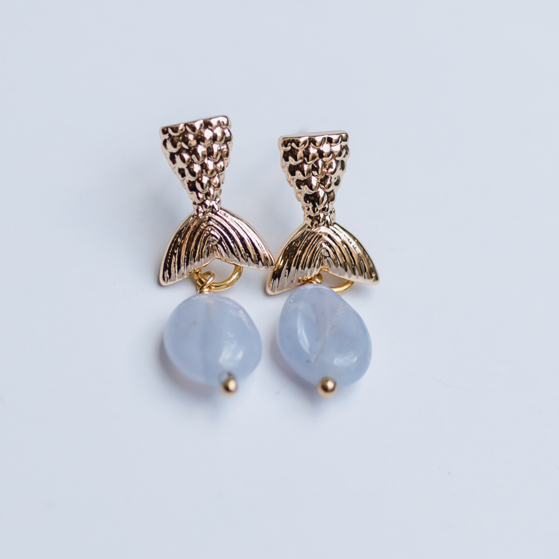 Gold mermaid tail with blue stone drop earring