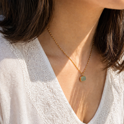 gold necklace with green stone pendant 