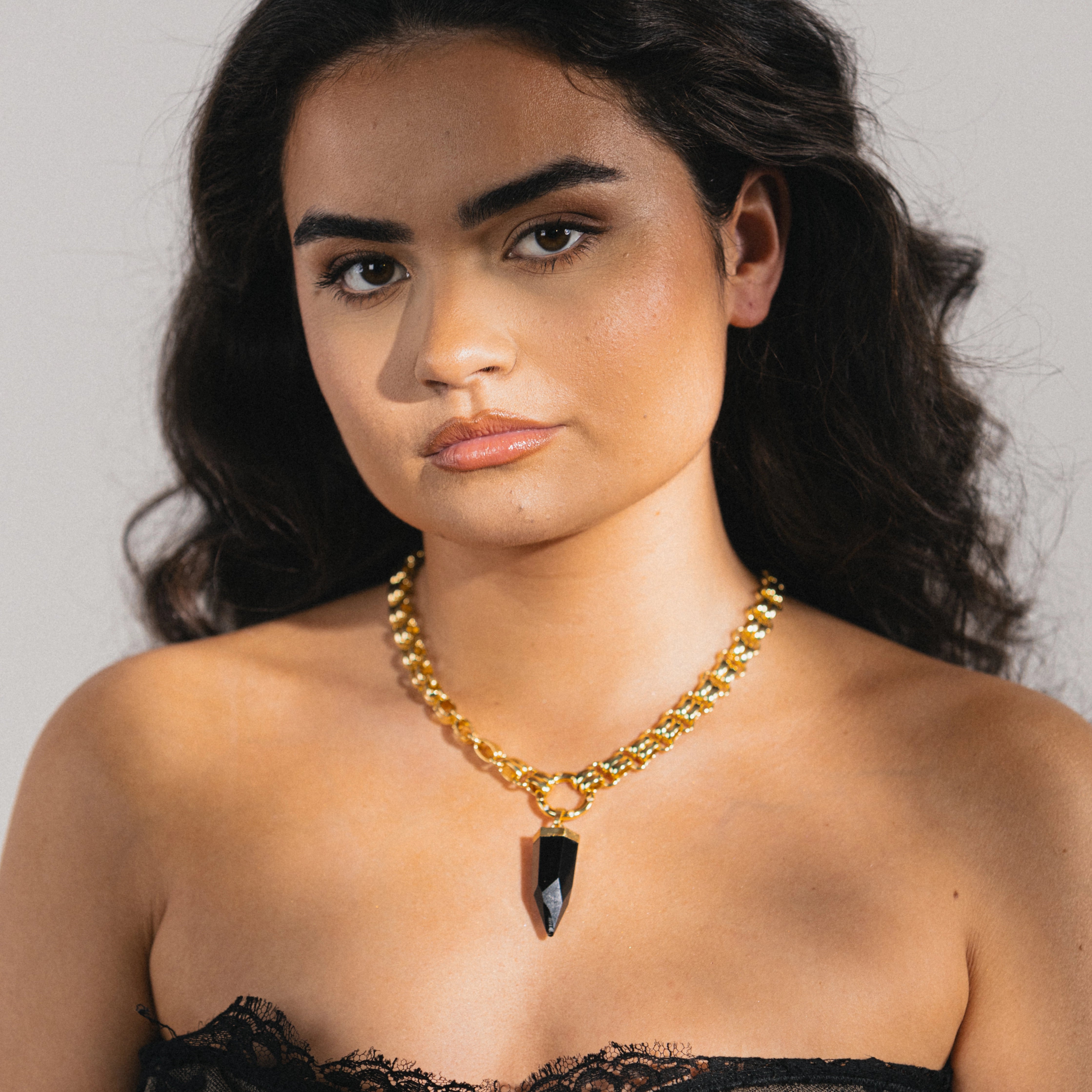 gold necklace with obsidian gemstone
