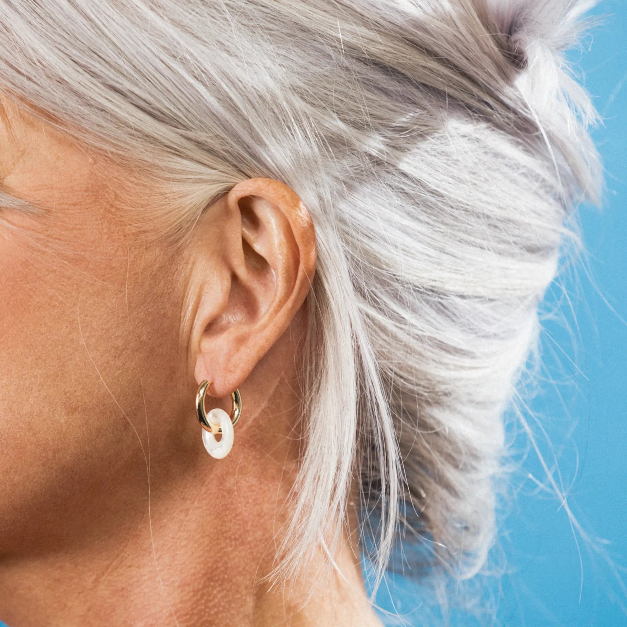 gold hoops with mother of pearl ring