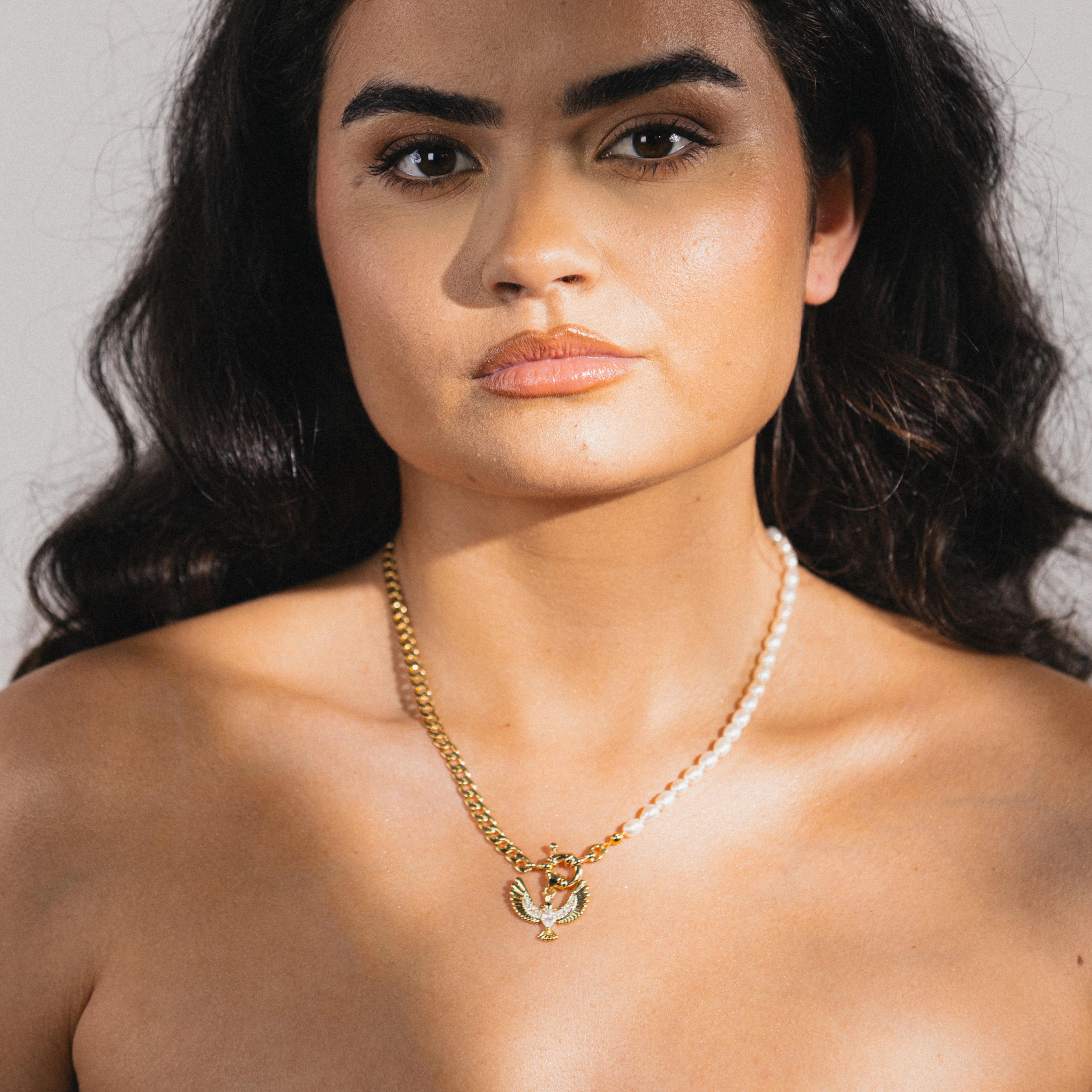 pearl and gold necklace with bird pendant 
