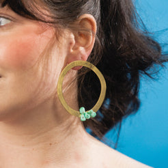 large gold hoop statement earrings with blue stones 