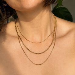triple layer gold necklace on neck 